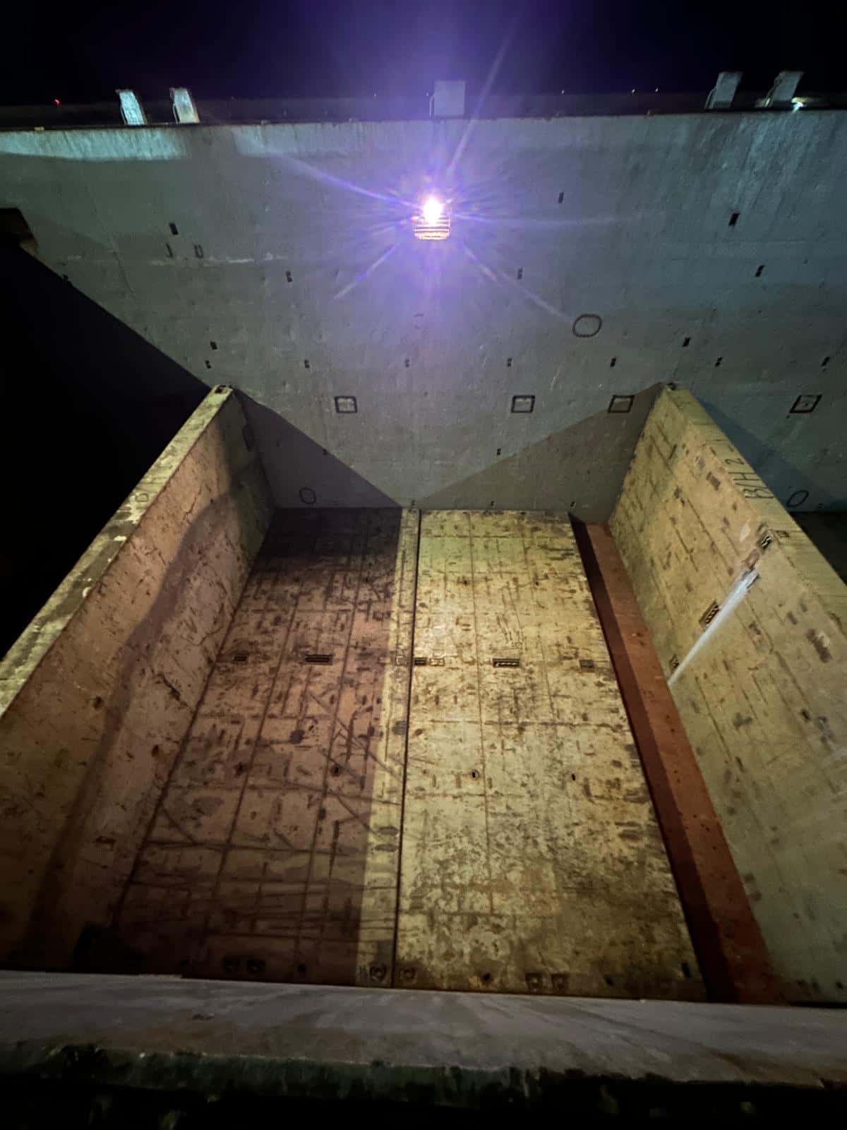 Night-time cargo-operation preparation inside an MV EBRU hold.